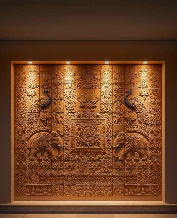 Terracotta tile mural with elephants, peacocks and ornamental patterns