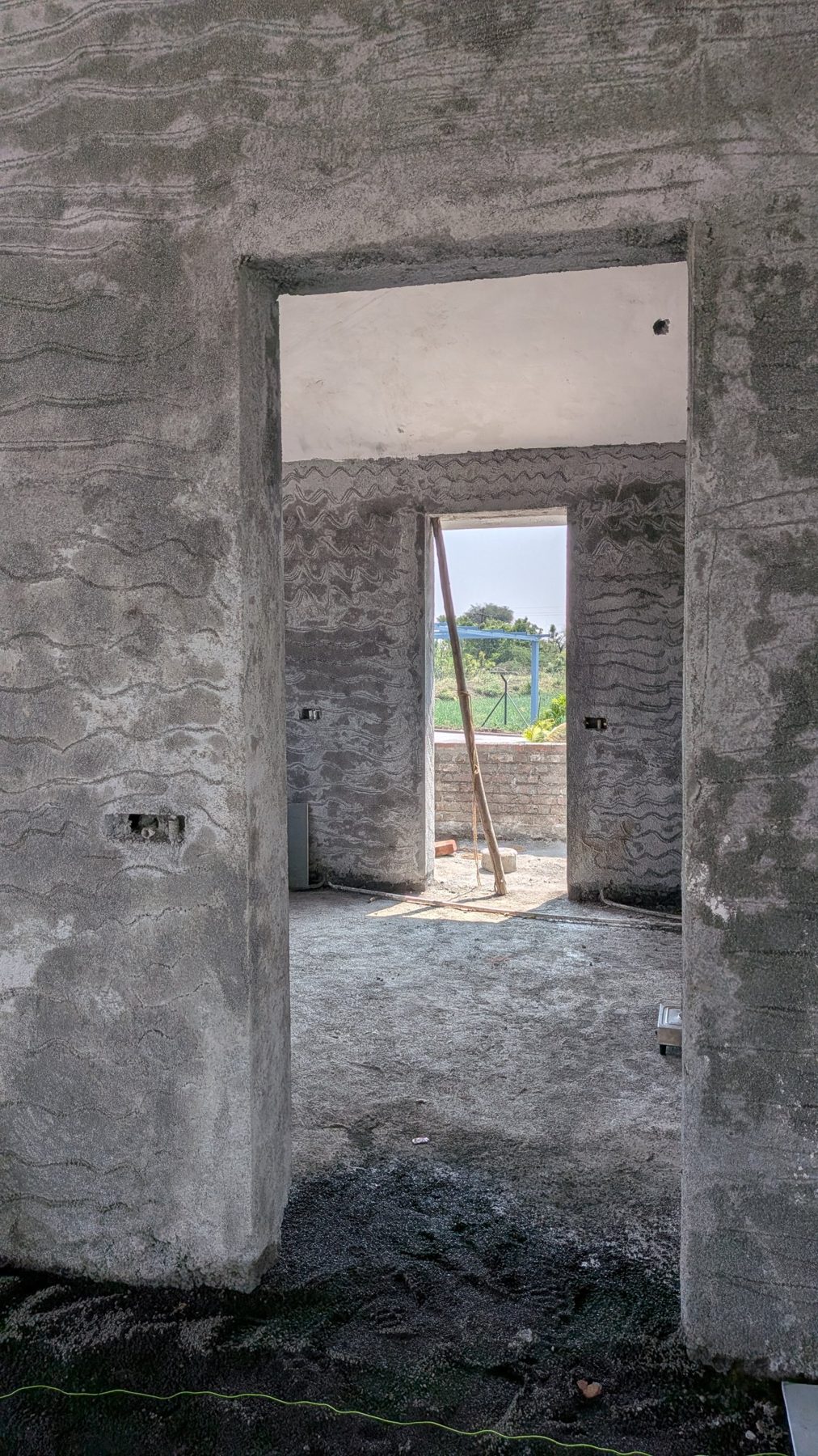 Plastered doorways framing a view through the house, site photo
