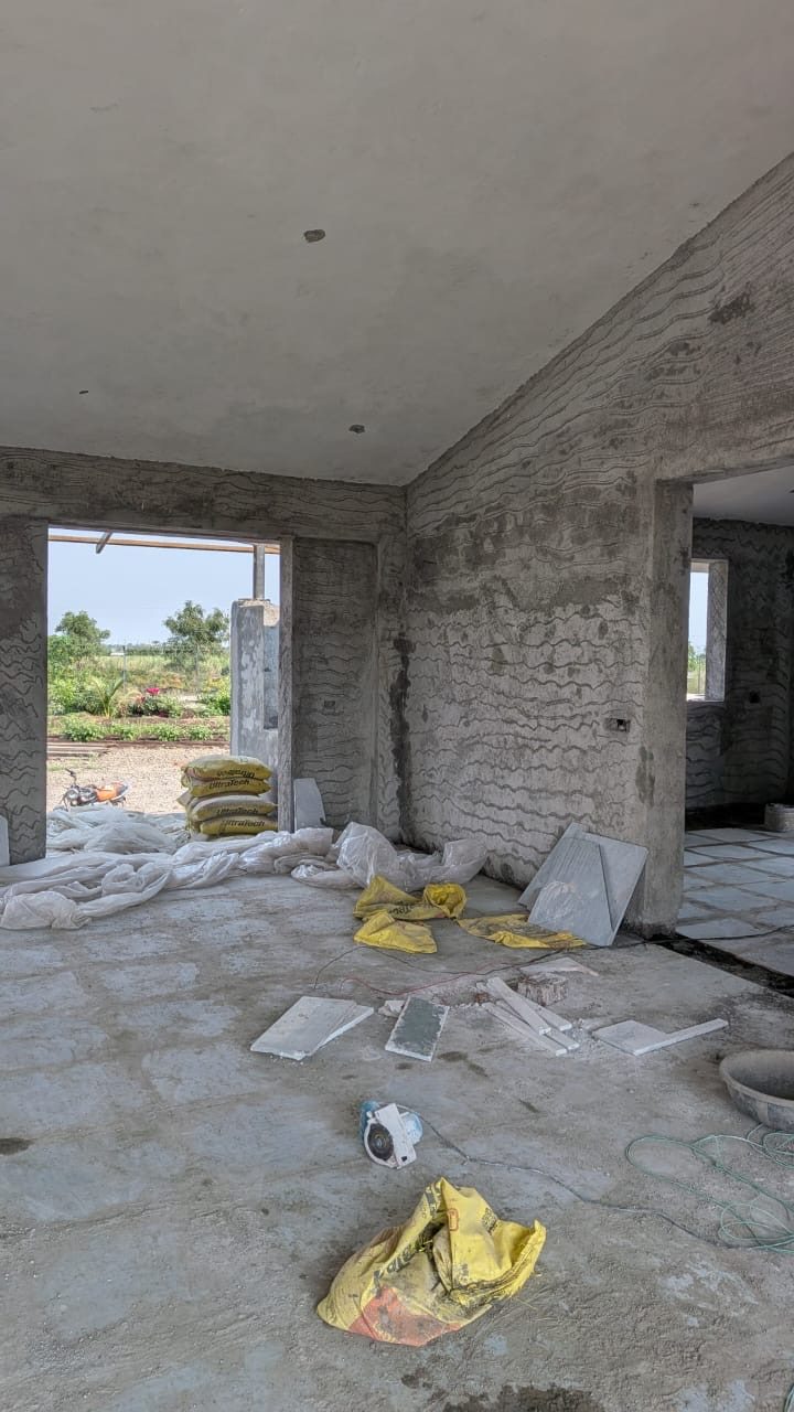 Flooring tiles being laid in the plastered living space, site photo