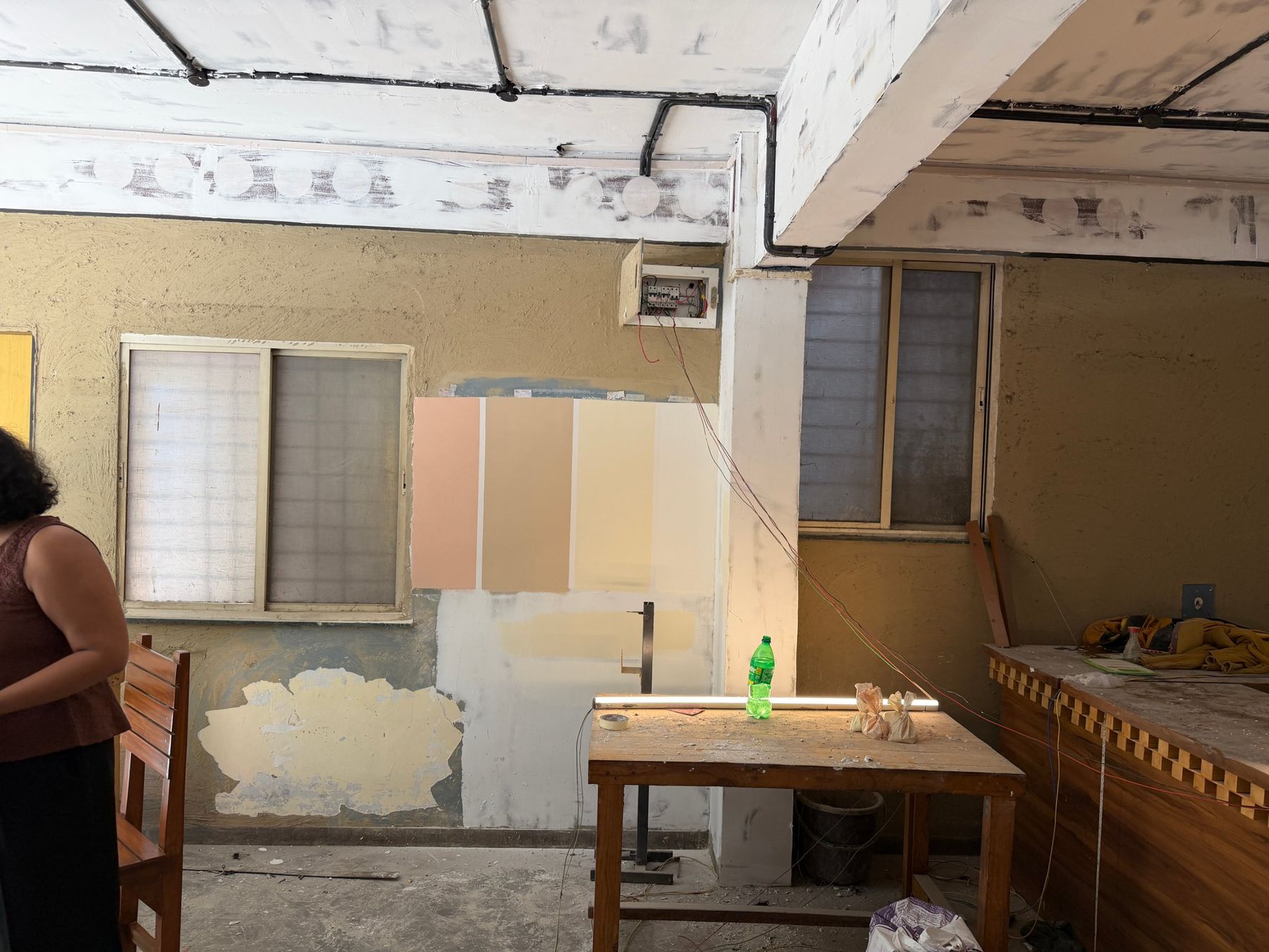 Mid-refurbishment: paint samples on the wall, conduits on the ceiling